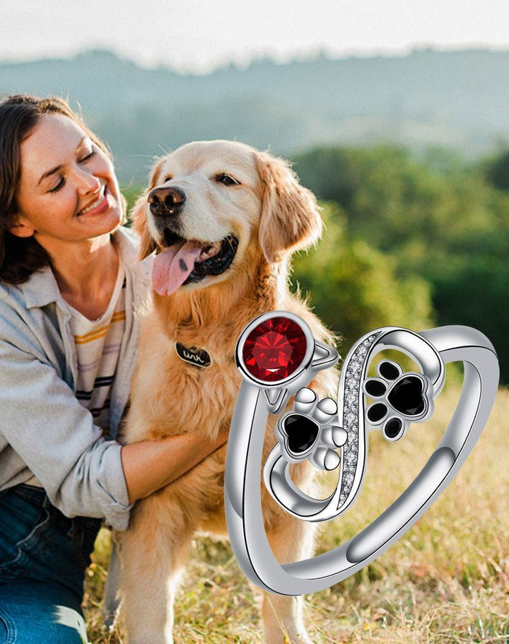 Adjustable ring with black paw print and red gemstones