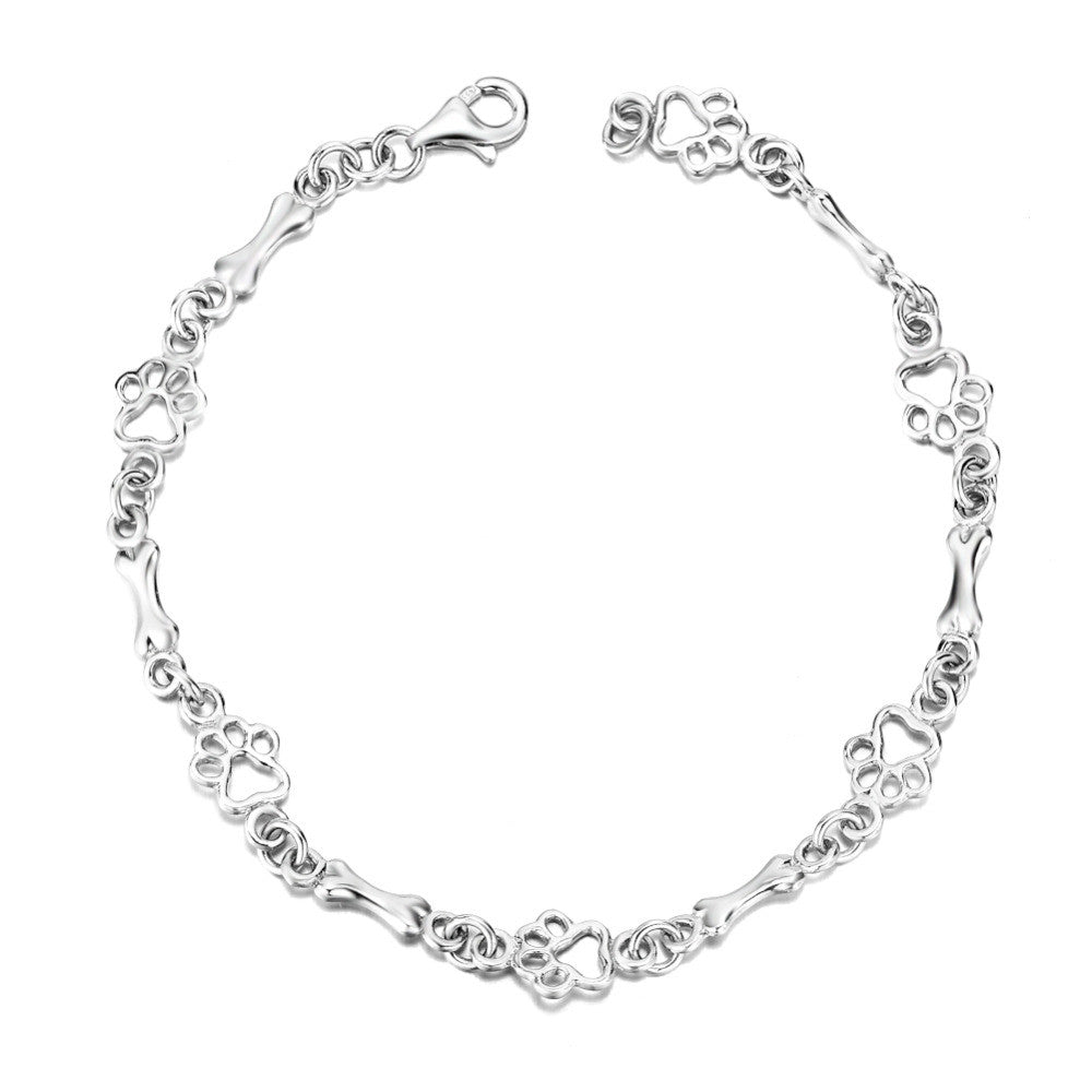 Bracciale con ciondoli a forma di zampa di cane e osso in argento