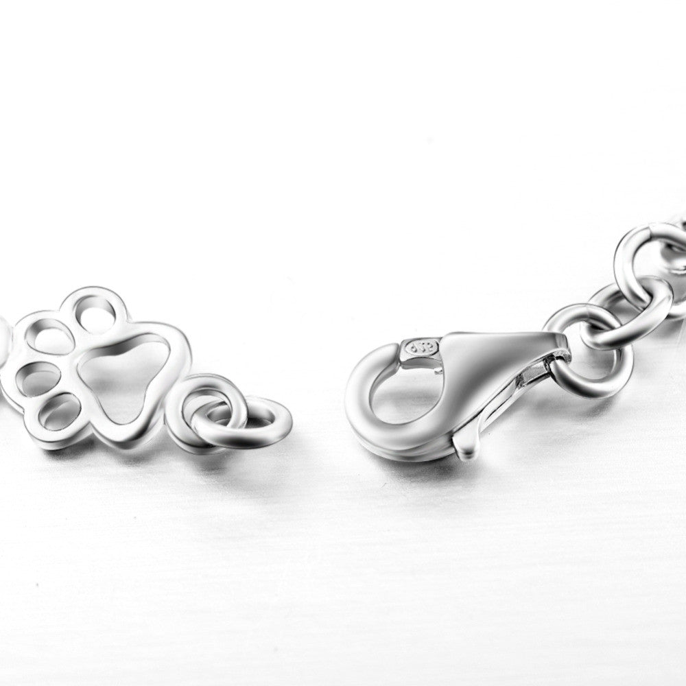 Bracciale con ciondoli a forma di zampa di cane e osso in argento