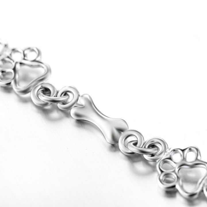 Bracciale con ciondoli a forma di zampa di cane e osso in argento