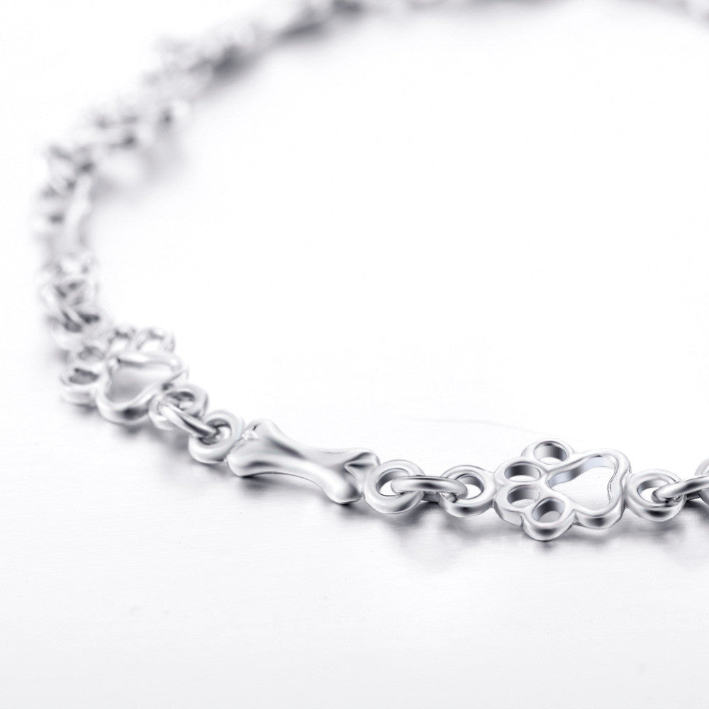 Bracciale con ciondoli a forma di zampa di cane e osso in argento