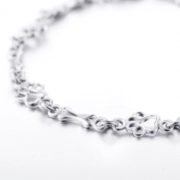 Bracciale con ciondoli a forma di zampa di cane e osso in argento
