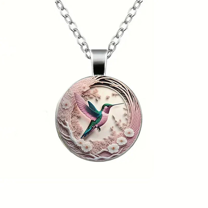 Necklace with glass dome pendant featuring a hummingbird