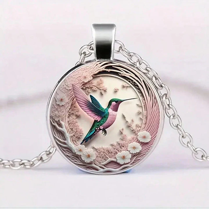 Necklace with glass dome pendant featuring a hummingbird