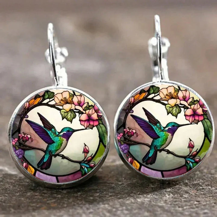 Necklace with glass dome pendant featuring a hummingbird