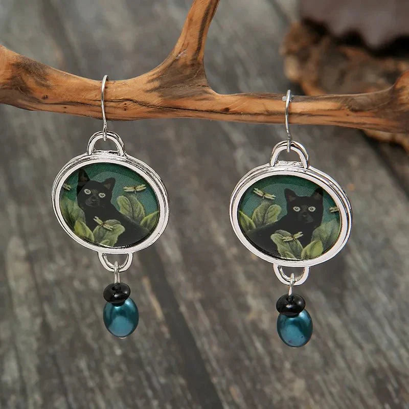 Vintage dangling earrings with tropical black cat