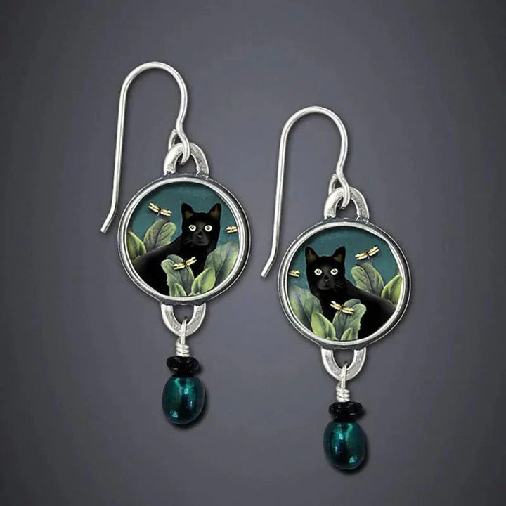 Vintage dangling earrings with tropical black cat
