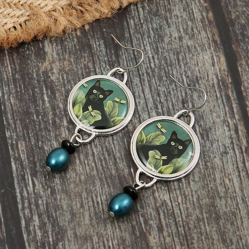 Vintage dangling earrings with tropical black cat