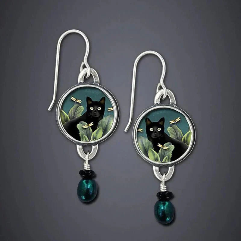 Vintage dangling earrings with tropical black cat